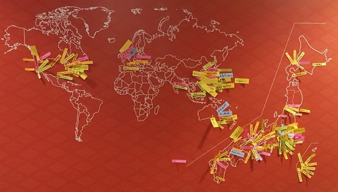 a world map with pieces of paper showing where everyone is from